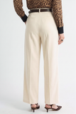 Back view of Oyster Belted Wide Leg Trousers in a neutral tone, styled with a dark belt, paired with pointed-toe heels and a leopard print blouse, showcasing a clean silhouette ideal for a timeless capsule wardrobe.