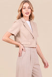 Model wearing a Riviera Linen Tailored Blazer-Khaki styled with matching high-waisted trousers, showcasing a clean, minimalist silhouette perfect for a timeless capsule wardrobe.