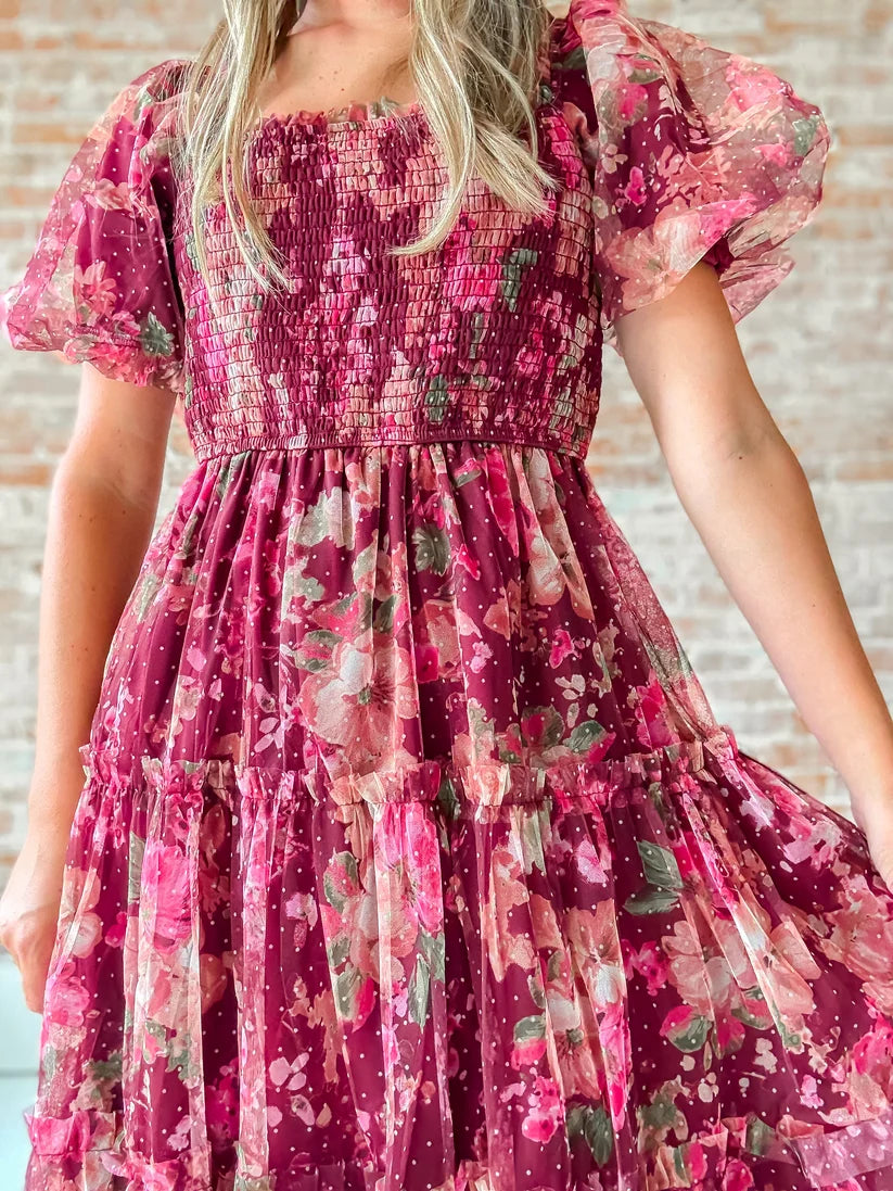 The Autumn Enchanted Orchard Tiered Tulle Midi Dress in a berry floral print with puff sleeves, smocked bodice, and flowing tiered skirt