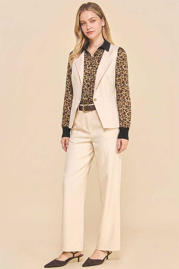 Woman wearing Oyster Belted Wide Leg Trousers paired with a leopard print blouse and beige sleeveless blazer, styled for a timeless, modern capsule wardrobe look.