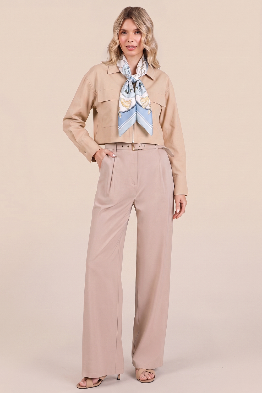 Model wearing The Portofino Linen Set in neutral tones, styled with a light blue patterned scarf, showcasing clean lines and timeless minimalism for a capsule wardrobe essential.