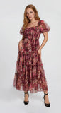 The Autumn Enchanted Orchard Tiered Tulle Midi Dress in a berry floral print with puff sleeves, fitted waist, tiered tulle skirt, and black heels