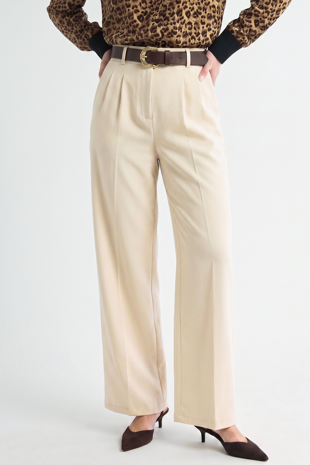 Oyster Belted Wide Leg Trousers in a light neutral shade featuring a belted waist and elegant wide leg cut, styled with dark brown heels and a leopard print top for a modern, timeless look.