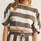 The Miou Muse Boat Neck Stripe Top in earthy tones features a relaxed fit and boat neckline, perfect for a timeless minimalist capsule wardrobe with versatile, clean style.