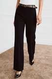 The Worth Avenue Trousers in black feature a clean, tailored silhouette with a high waist, paired with a brown belt and glossy black pointed-toe heels for a refined, minimalist look.